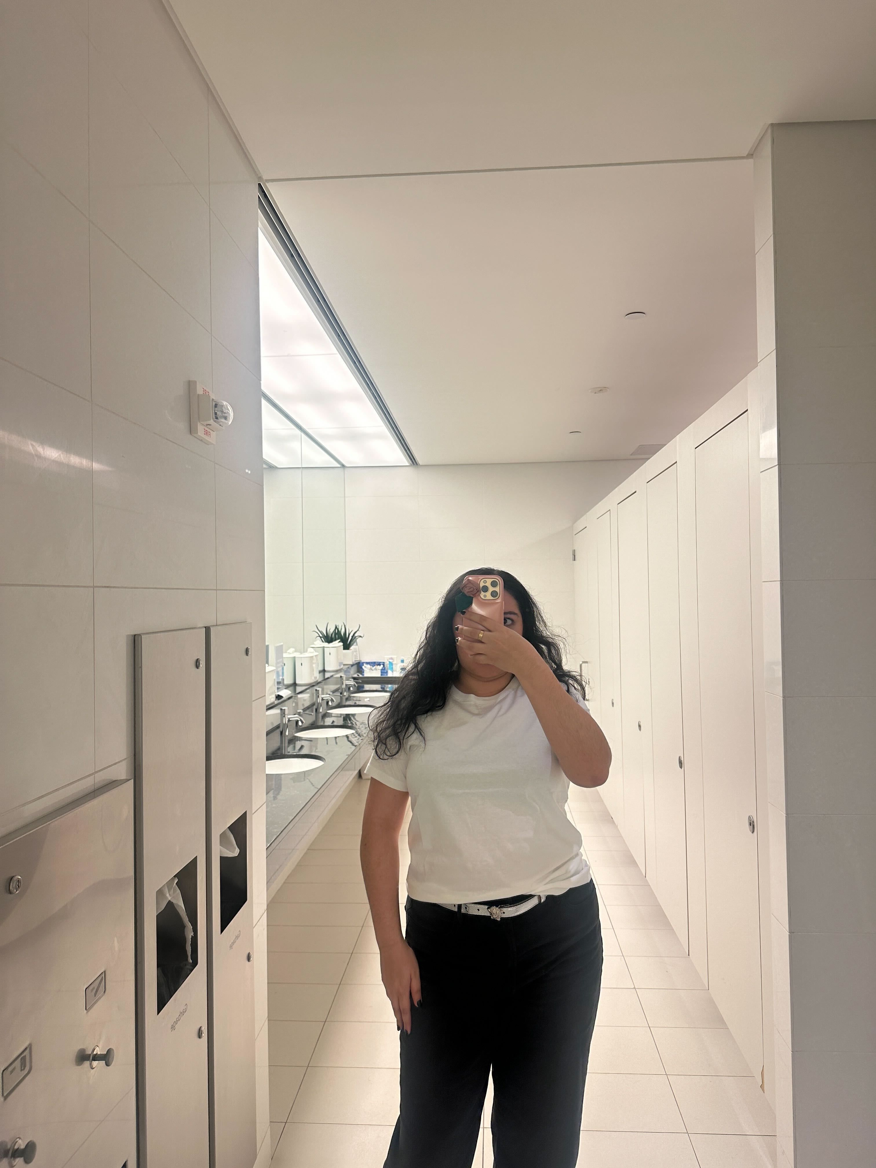 a person posing in a restroom with a clean and modern design