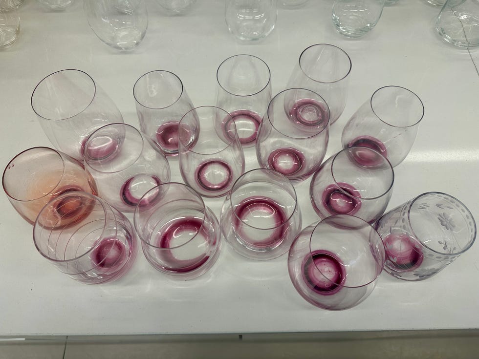 15 stemless wine glasses with wine inside