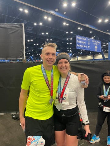 two marathon finishers celebrating with medals