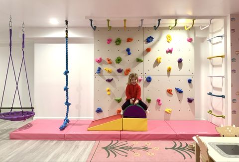 a rock climbing wall and monkey bars by smart d2 playrooms in parker bowie larson's home