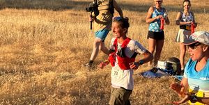 courtney dauwalter runs past aid station at western states