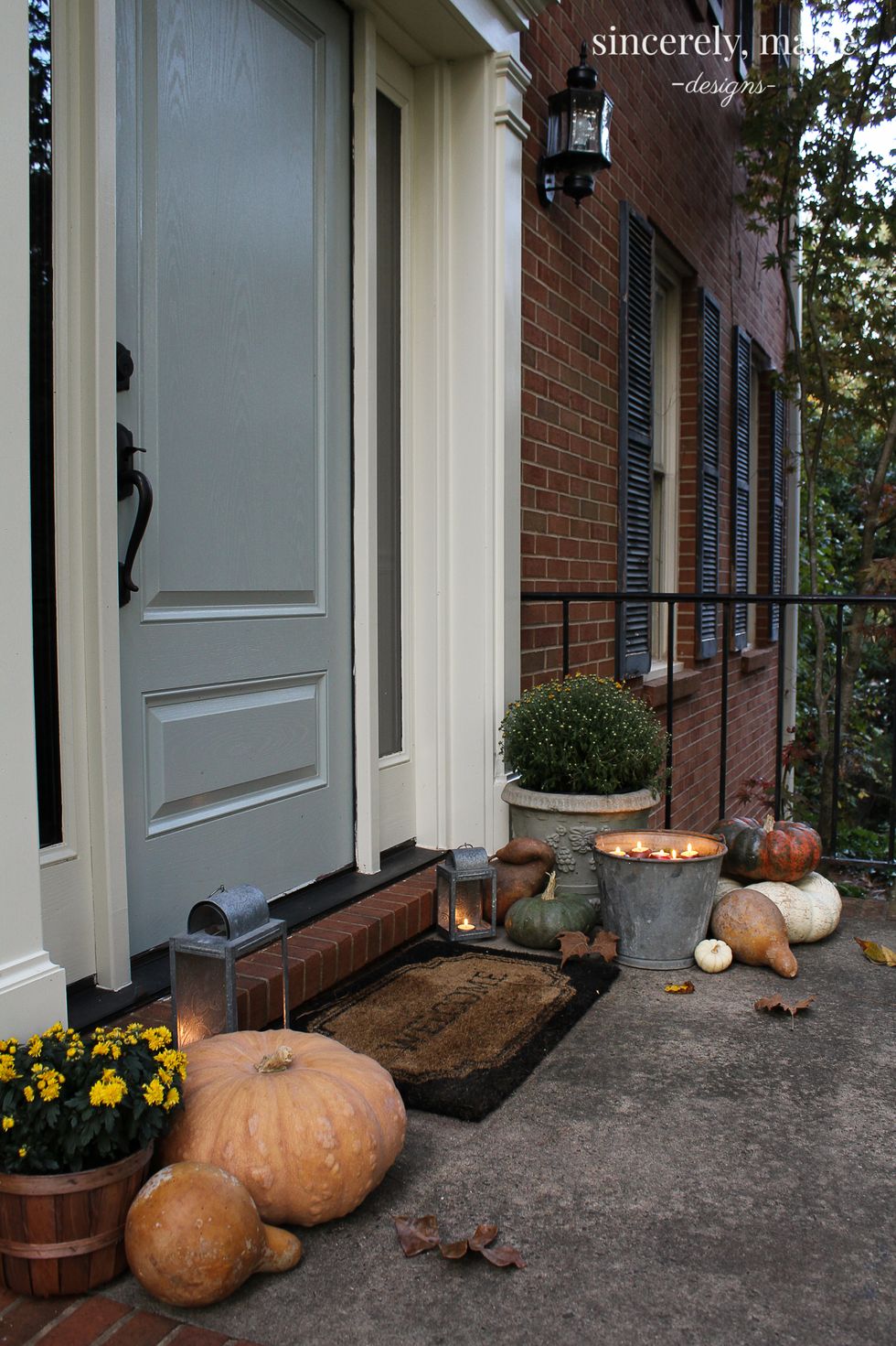 fall front porch with pumpkins and candlelight