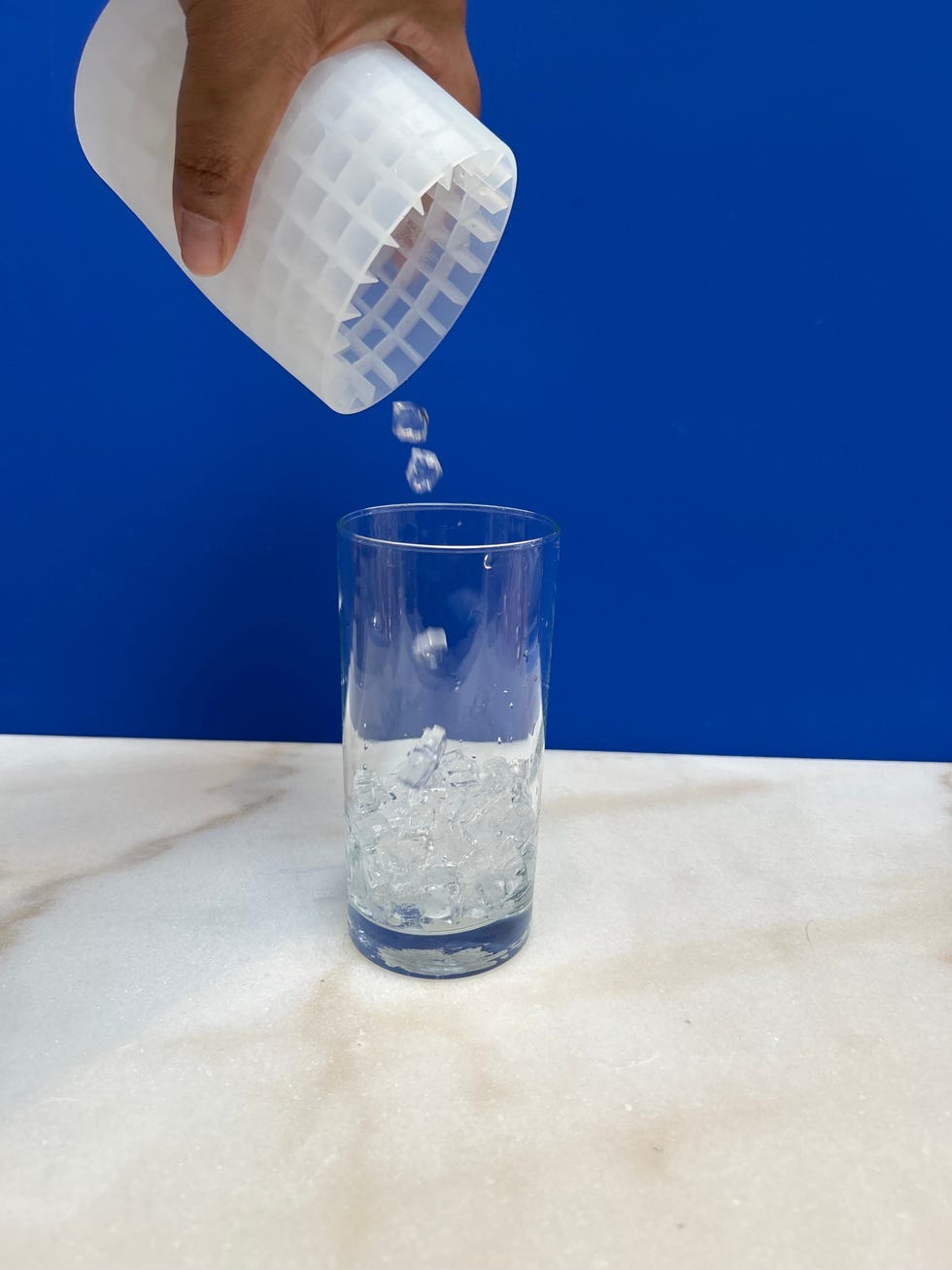 pouring ice into a cup