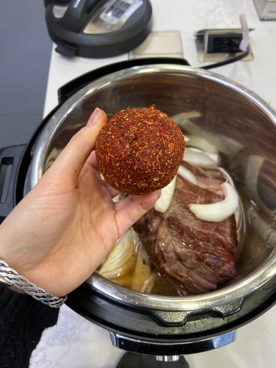 a person holding a pan of food