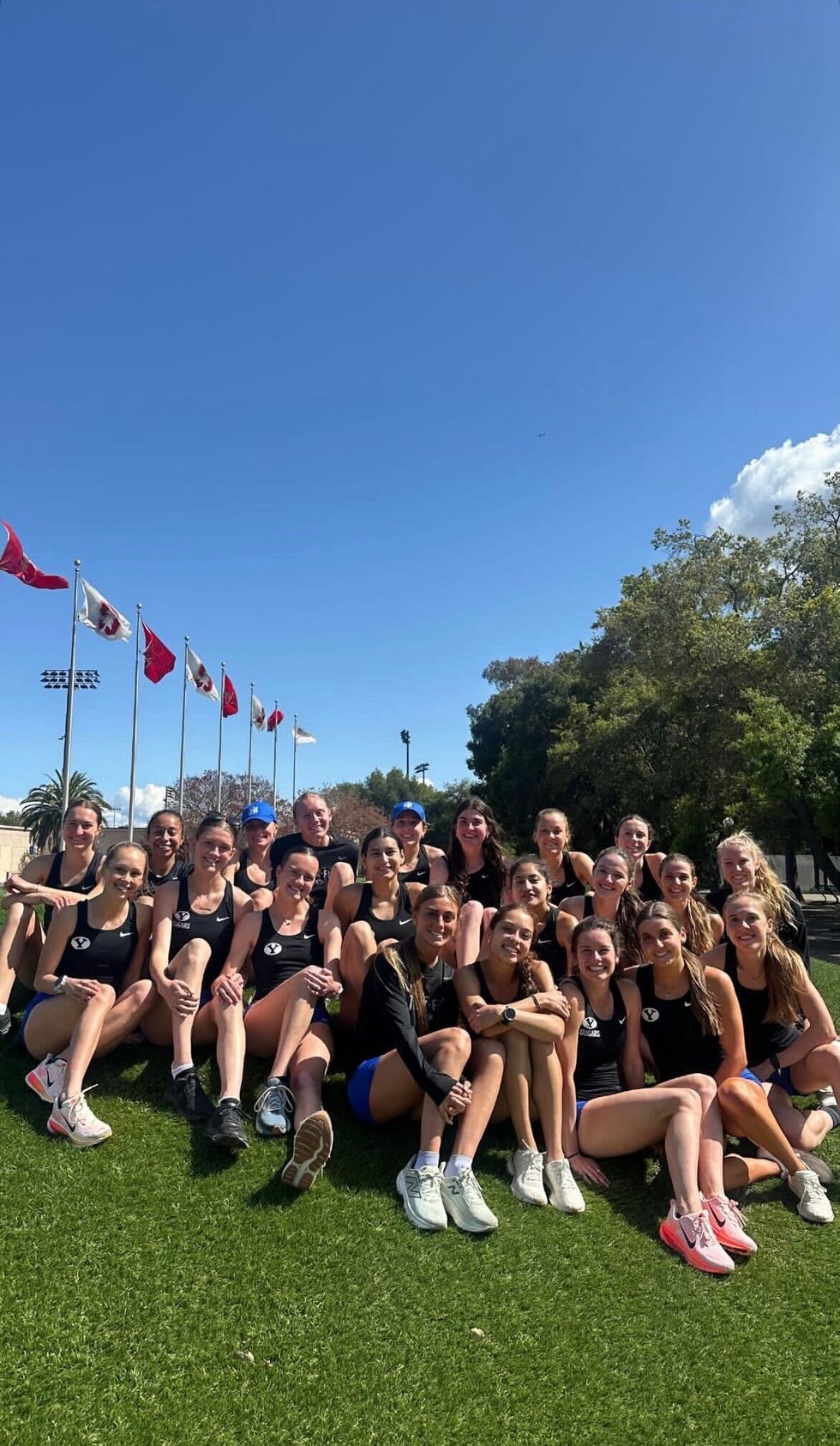 group of athletes posing together outdoors