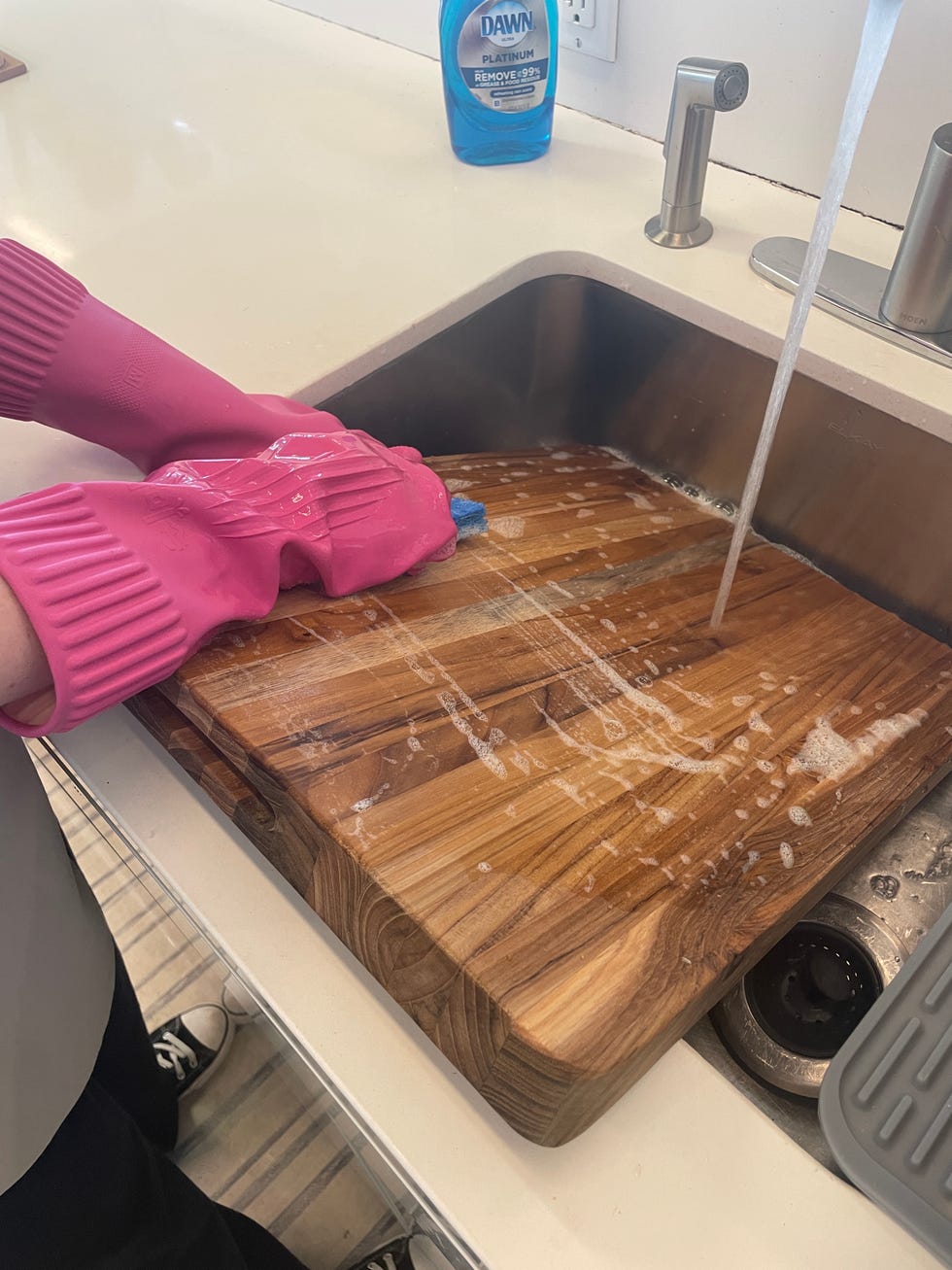 washing cutting board in sink
