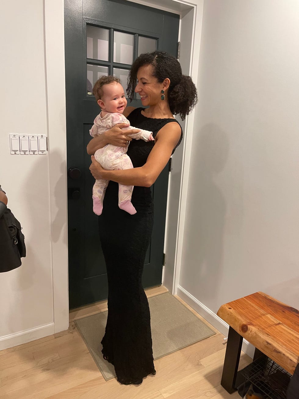 an adult woman holding a young child in a home setting