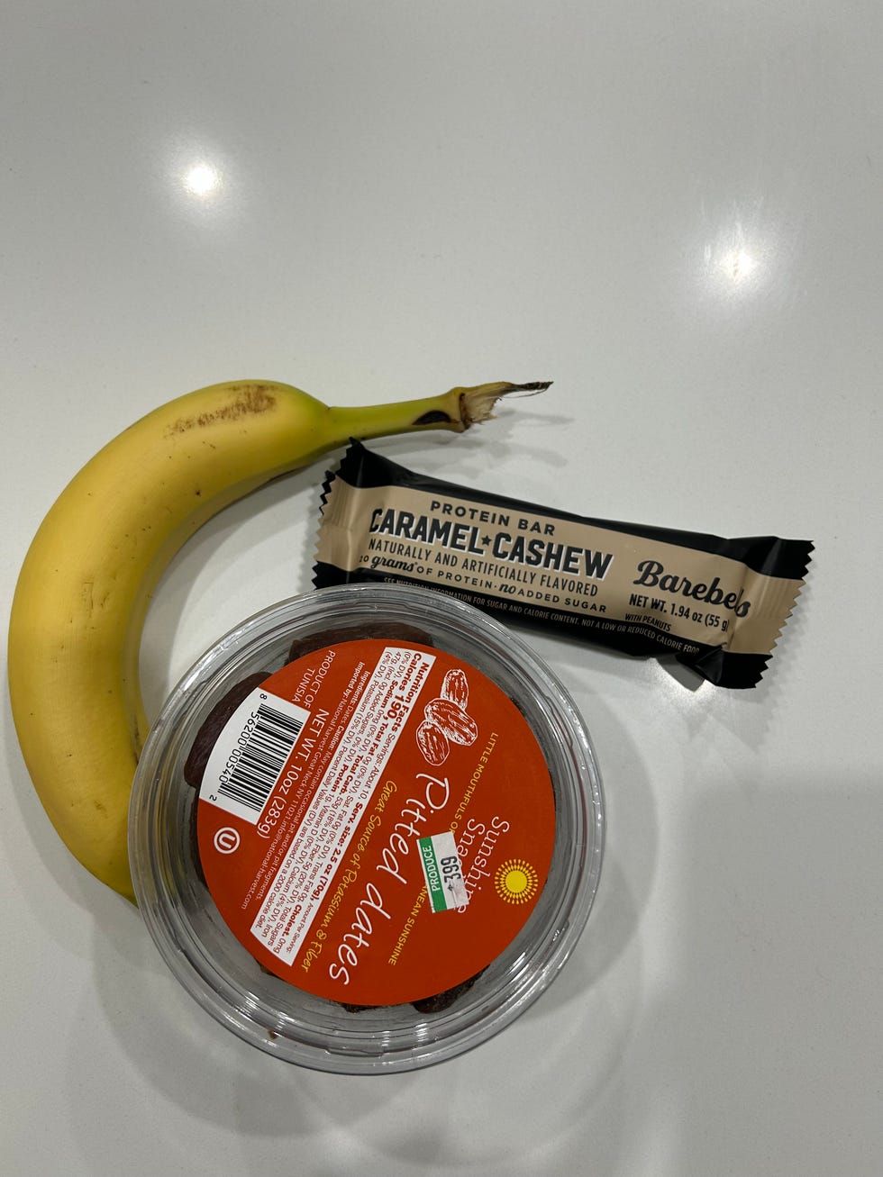 ava's go to pre walk morning snack: a protein bar, banana, and dried dates.