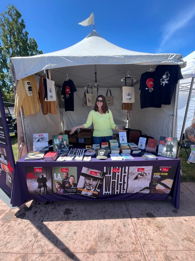 a person standing next to a table with a display of items