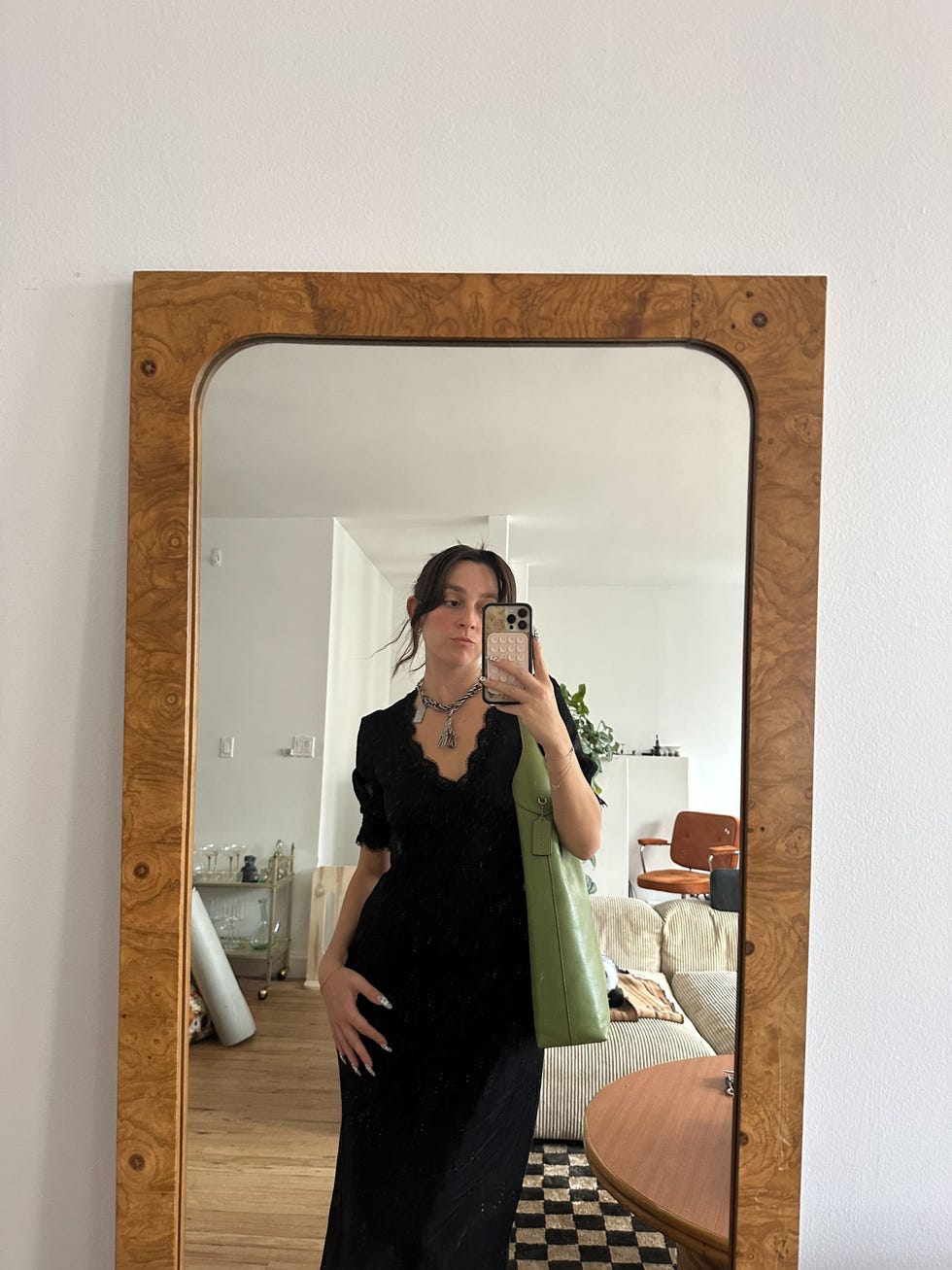 individual stands in front of a mirror showcasing attire