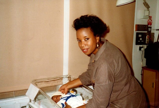 a woman holding a baby