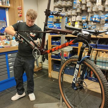 een fietsenmaker bouwt een mountainbike op