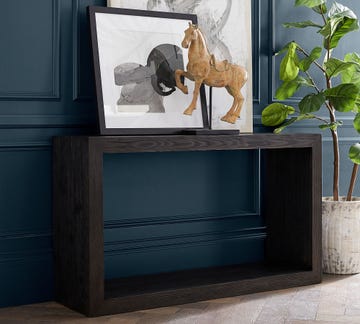 console table with decorative art and horse sculpture