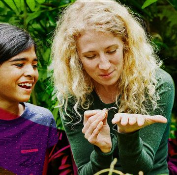 children learning from female environmentalist