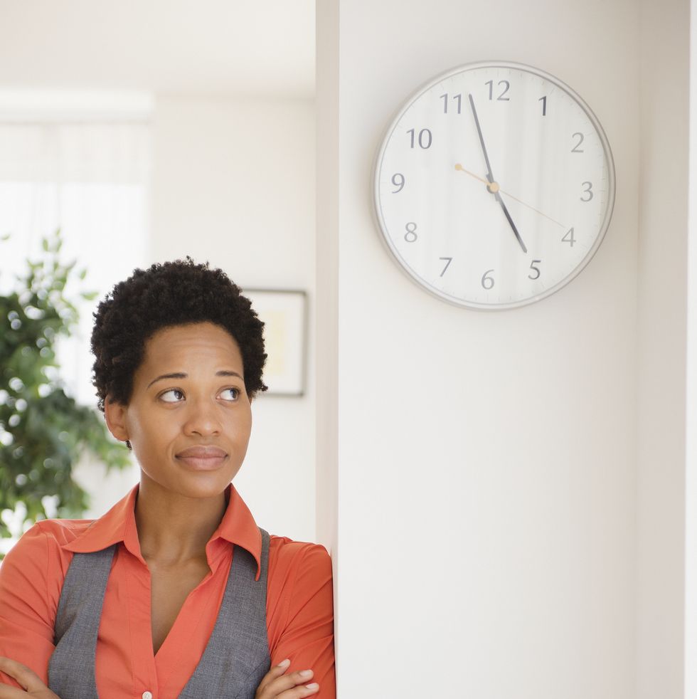 impatient african american businesswoman leaning against wall