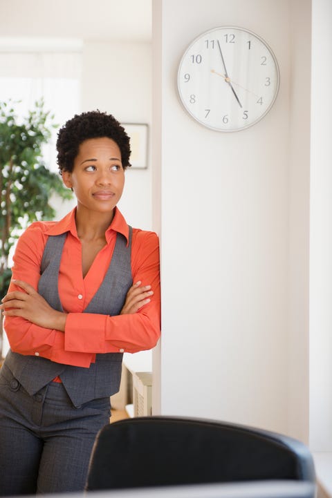 impatient african american businesswoman leaning against wall