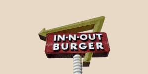in n out sign on a peach background