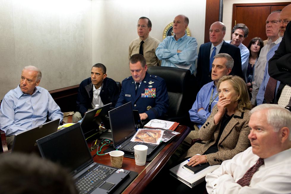 president obama sitting at a desk with his administration watching video footage