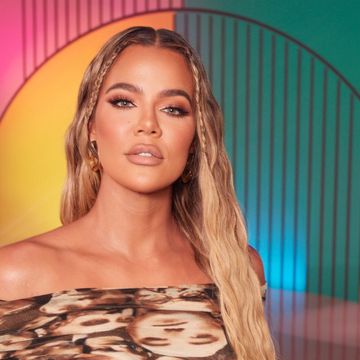 khloe kardashian poses in off shoulder dress with blonde hair and baby braids