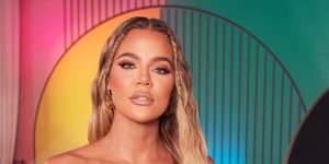 khloe kardashian poses in off shoulder dress with blonde hair and baby braids