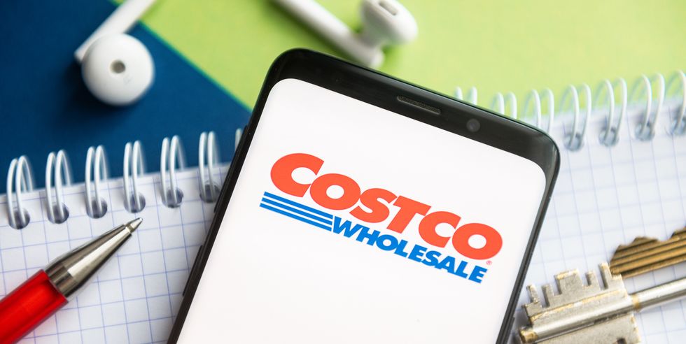 in this photo illustration, a costco logo seen displayed on