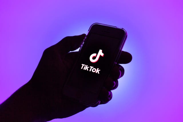 in this photo illustration, a tik tok logo seen displayed on