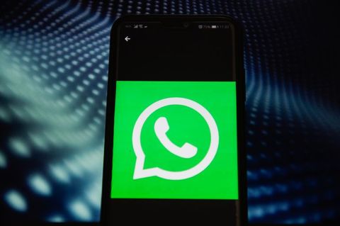 In this photo illustration a WhatsApp logo seen displayed on...