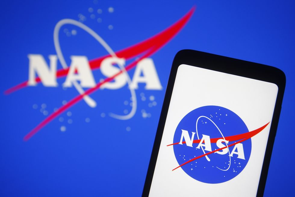 in this photo illustration, nasa logo is seen displayed on