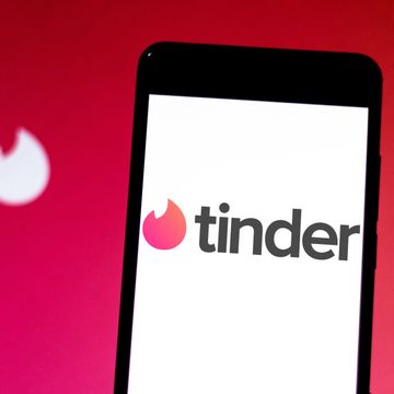 In this photo illustration Tinder logo seen displayed on a...