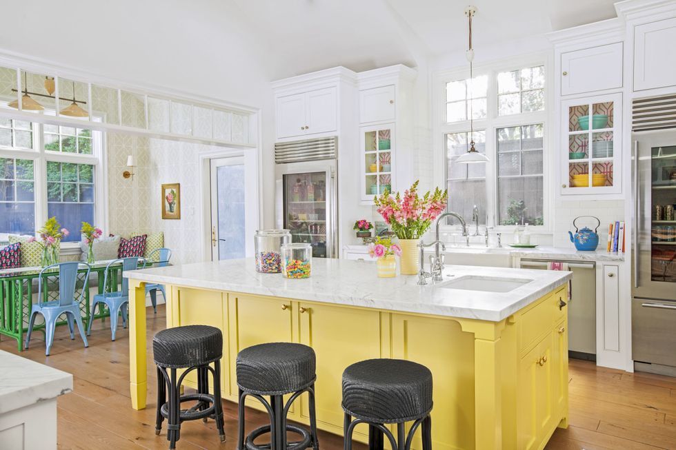 white kitchen with yellow island