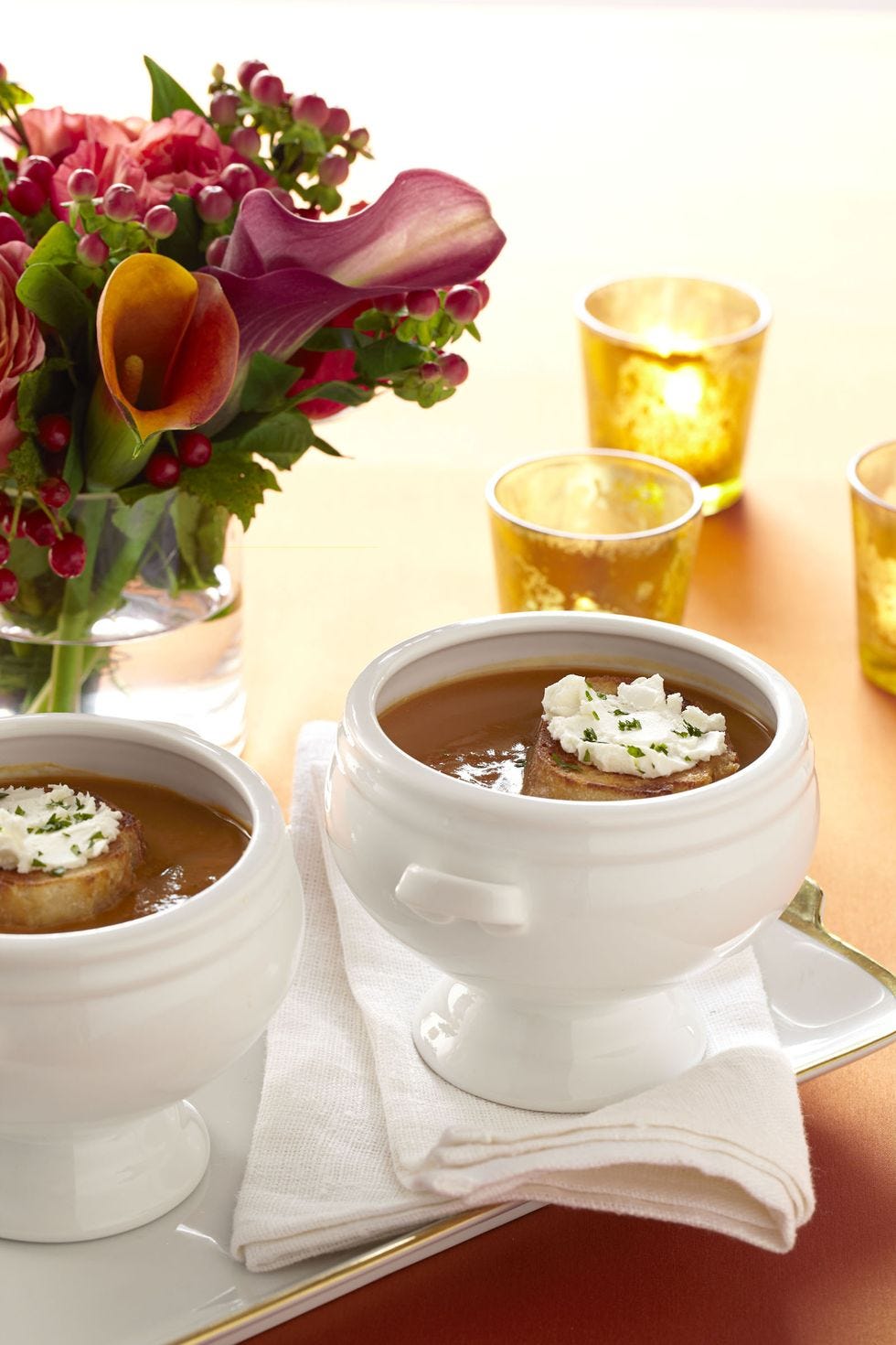 butternut squash and apple soup in a white bowl