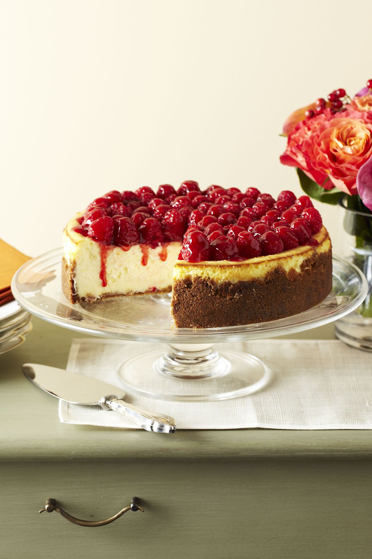 raspberry cheesecake on a white a cake stand