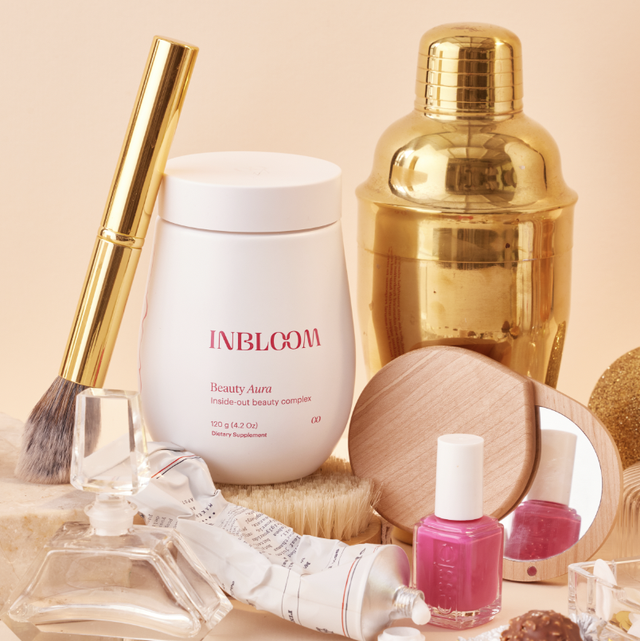 inbloom beauty aura powder on table with other beauty products