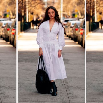 a woman wears a white midi dress in a roundup of the best midi dresses 2023