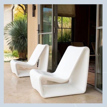 a group of white chairs in a room with a glass door