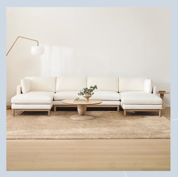 a living room with a white couch and a coffee table a living room with a white couch and a coffee table