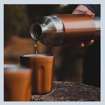 a person pouring a drink into a glass a person pouring a drink into a glass