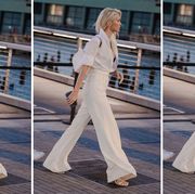 a woman wears an all white outfit to illustrate a roundup of the best summer pants 2022