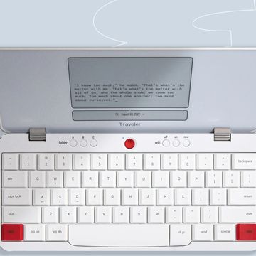 a white computer with a red button