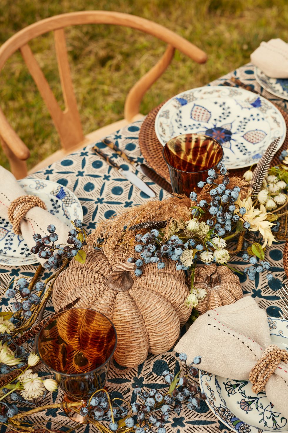 india hicks sets a fall table oka products including a blue tablecloth and tortoiseshell goblets