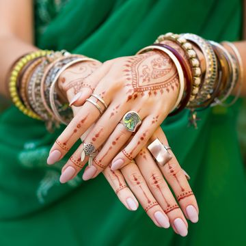 indian woman in traditional sari dress with henna tattoo