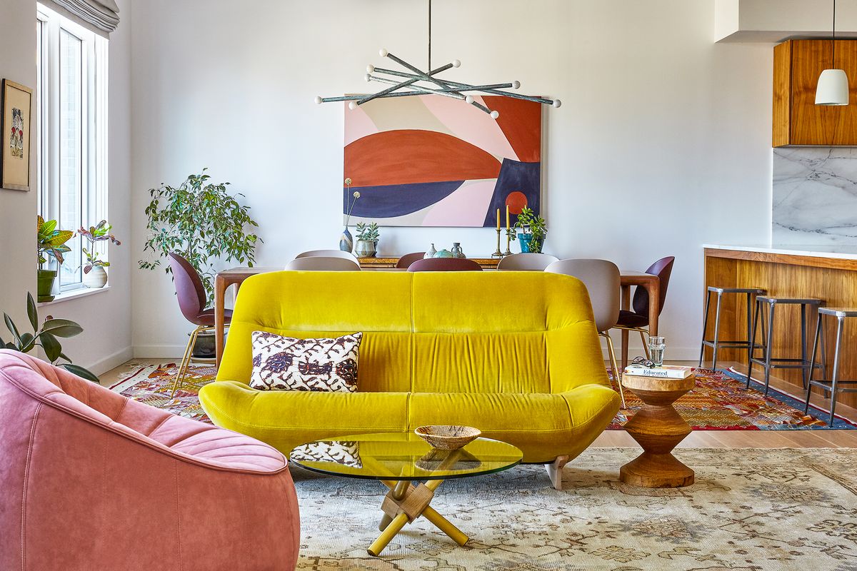 great room with abstract wall art and yellow sofa