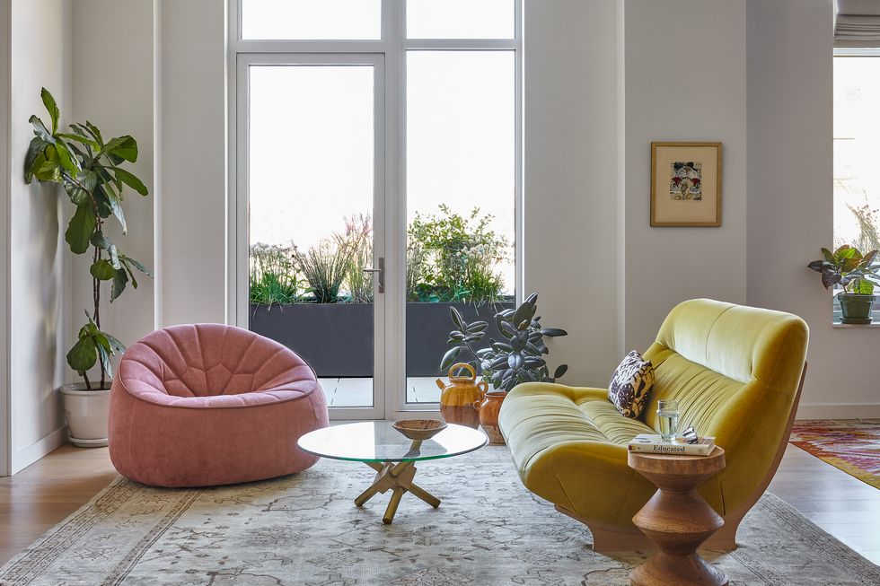 living room with pink chair and yellow sofa