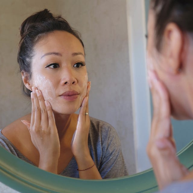 indonesian woman washing her face using beauty cleanser soap