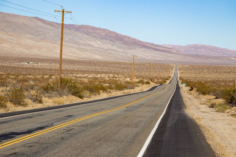 infinite straight road at the california desert during road trip