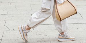 a woman walks in chloe sneakers to illustrate a guide to the most comfortable sneakers 2023