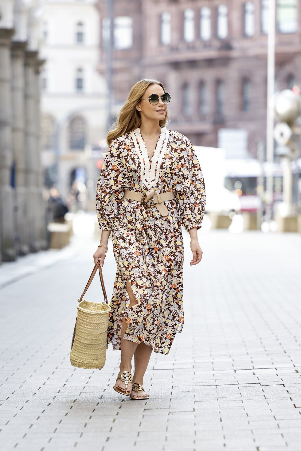 hamburg, germany   march 29 german actress lara isabelle rentinck wearing sunglasses by chloe, a long multicolored maxi dress with floral print by tory burch, a dark brown and beige bast bag by tory burch and gold sandals by tory burch during a street style shooting on march 29, 2021 in hamburg, germany photo by streetstyleshootersgetty images