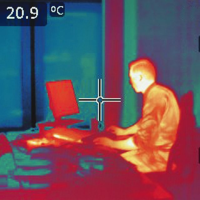 infrared heat image of office worker sitting at desk