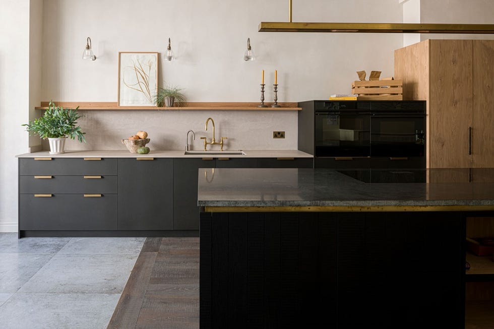 a kitchen with black counter tops