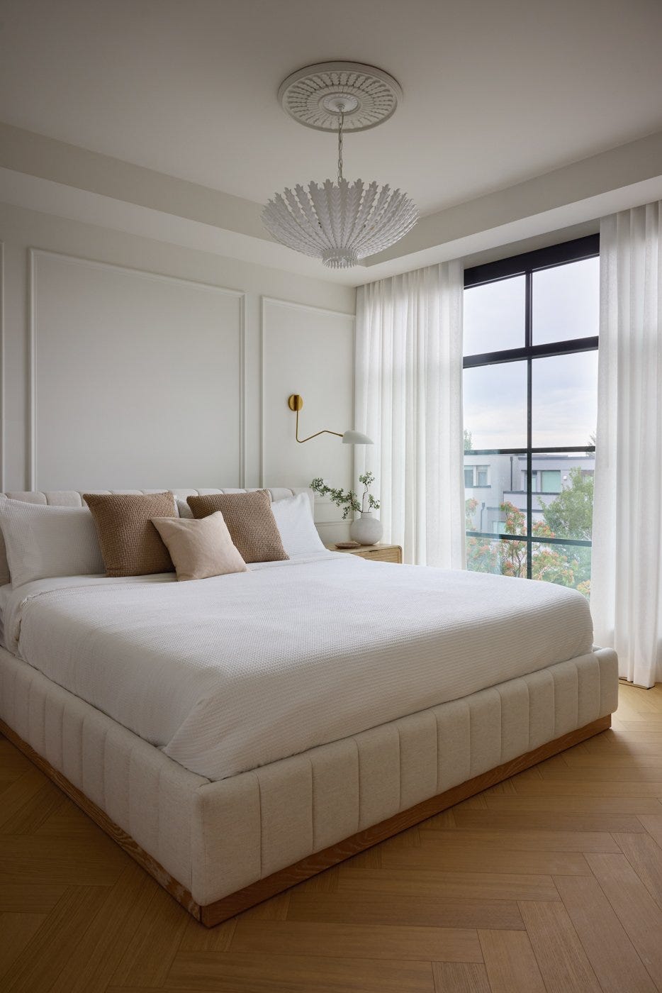 off white bedroom with upholstered bed